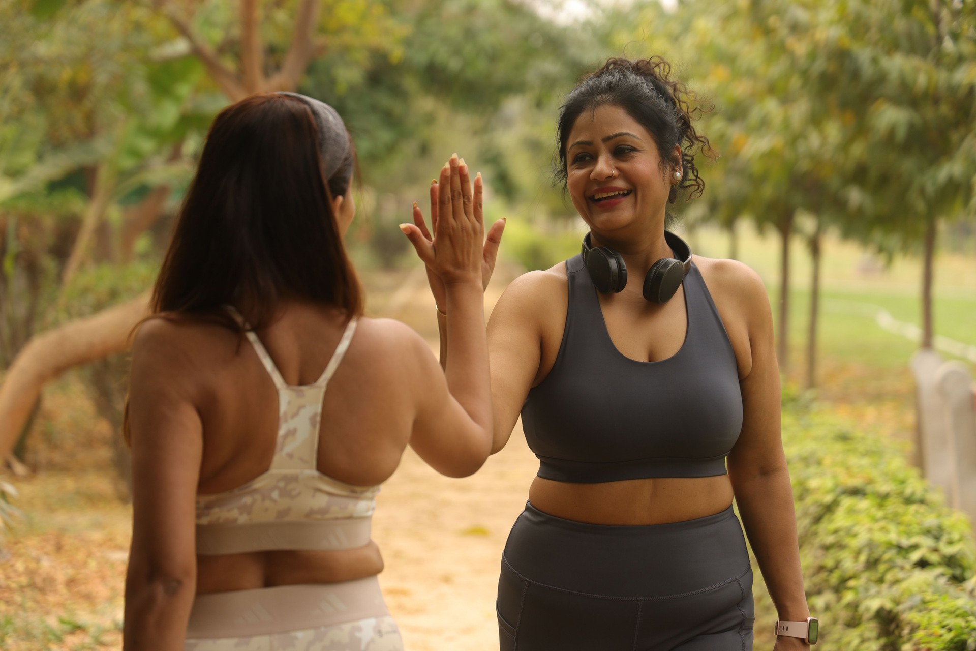 Youthful Happy Indian friends in their mid age jogging in the park on jogging tracks