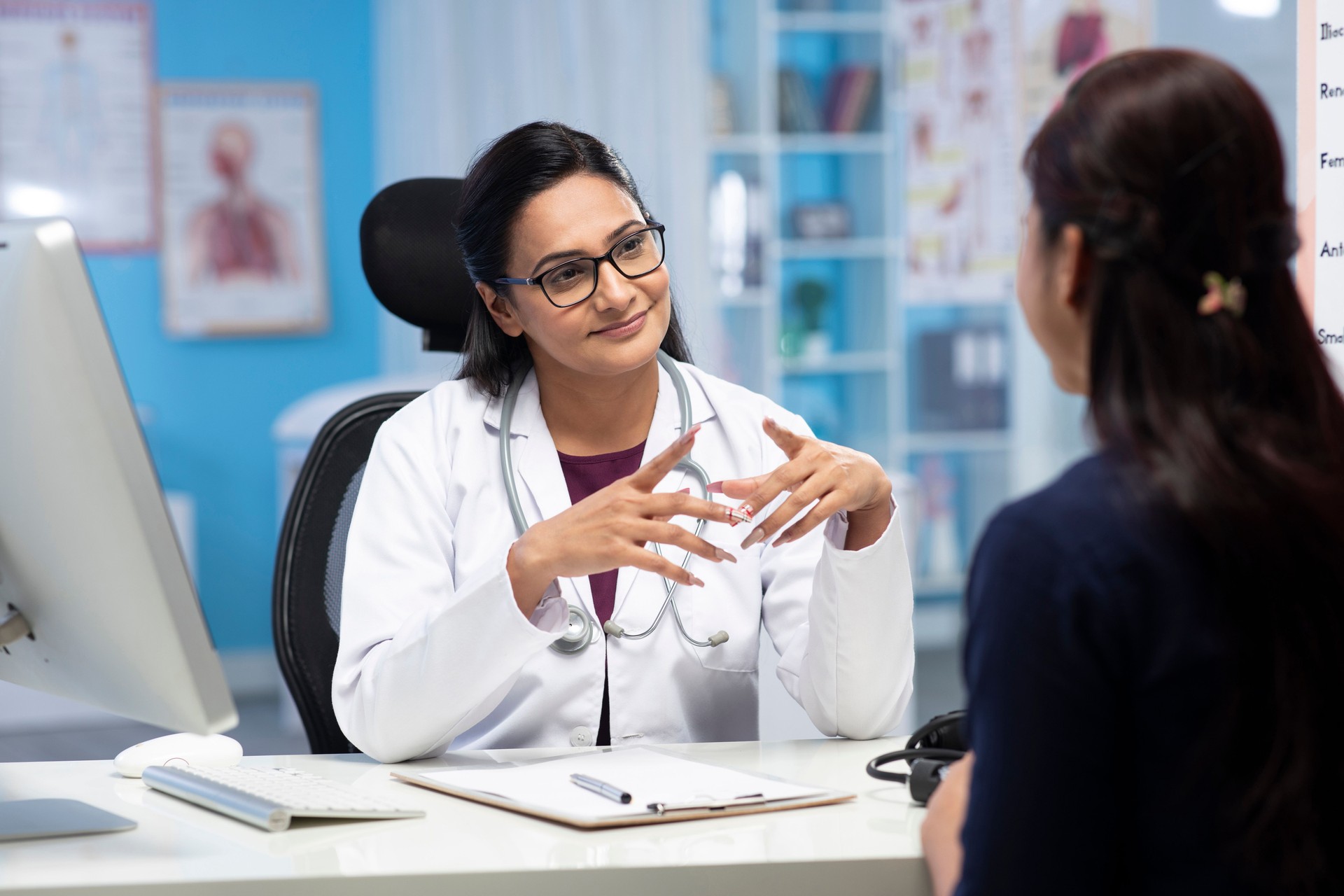 Doctor and patient are discussing at clinic and writting Prescription Medicine stock photo