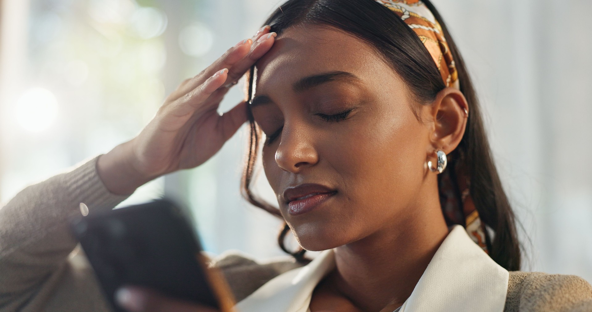 Headache, Indian woman and cellphone for pain, brain fog or hurt in home for telehealth. Internet, research or medical advice on website for online help, digital doctor or female person with migraine